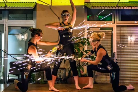 An acrobatic group performance with sparks