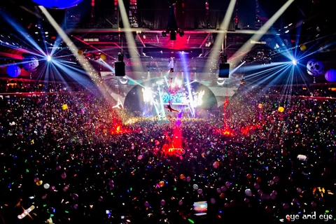 A packed New Year’s Eve arena filled with light